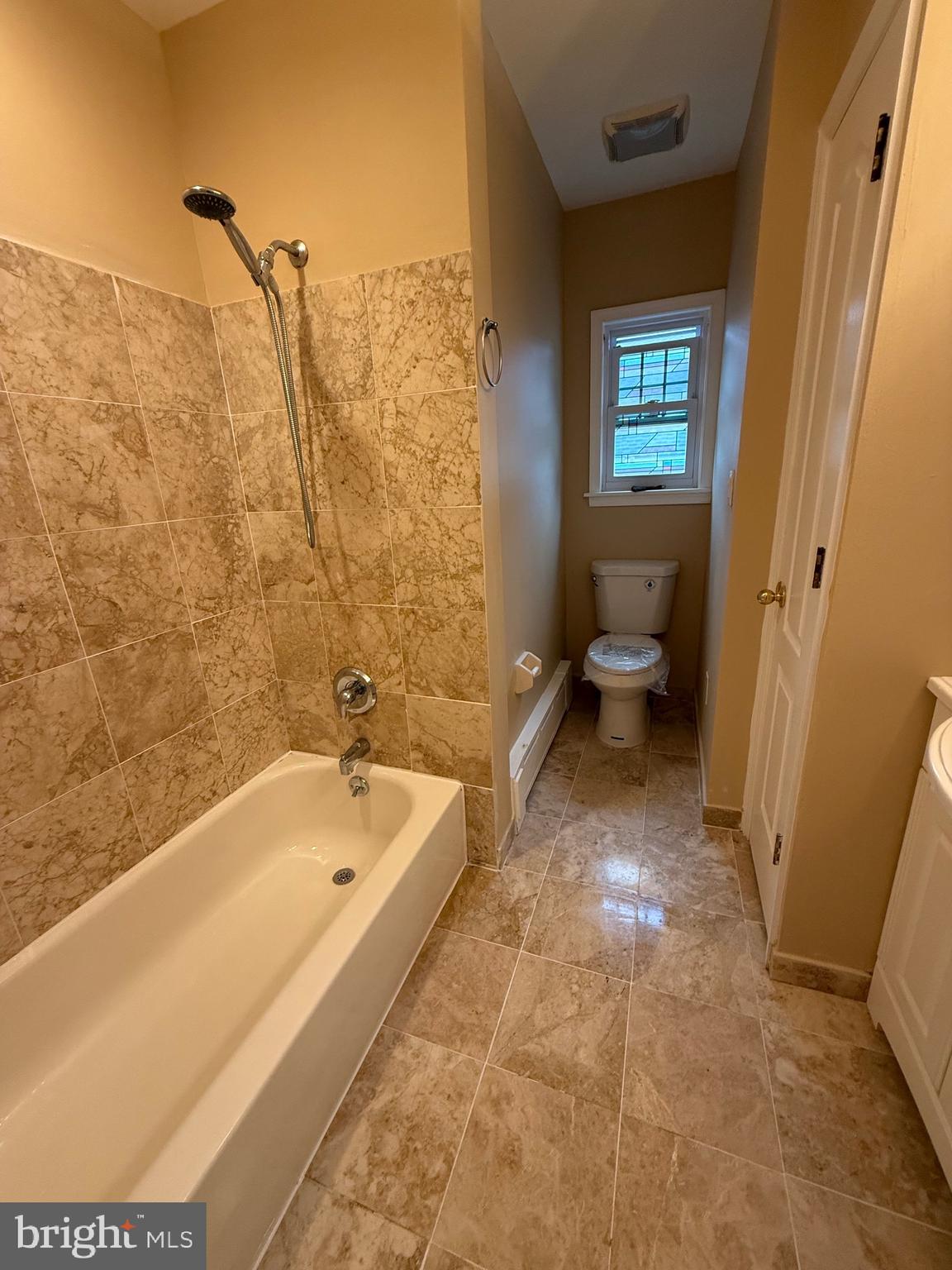 232 South Highland Road Springfield, PA 19064 - Photo 22 of 58 a bath room with a toilet and a bath tub