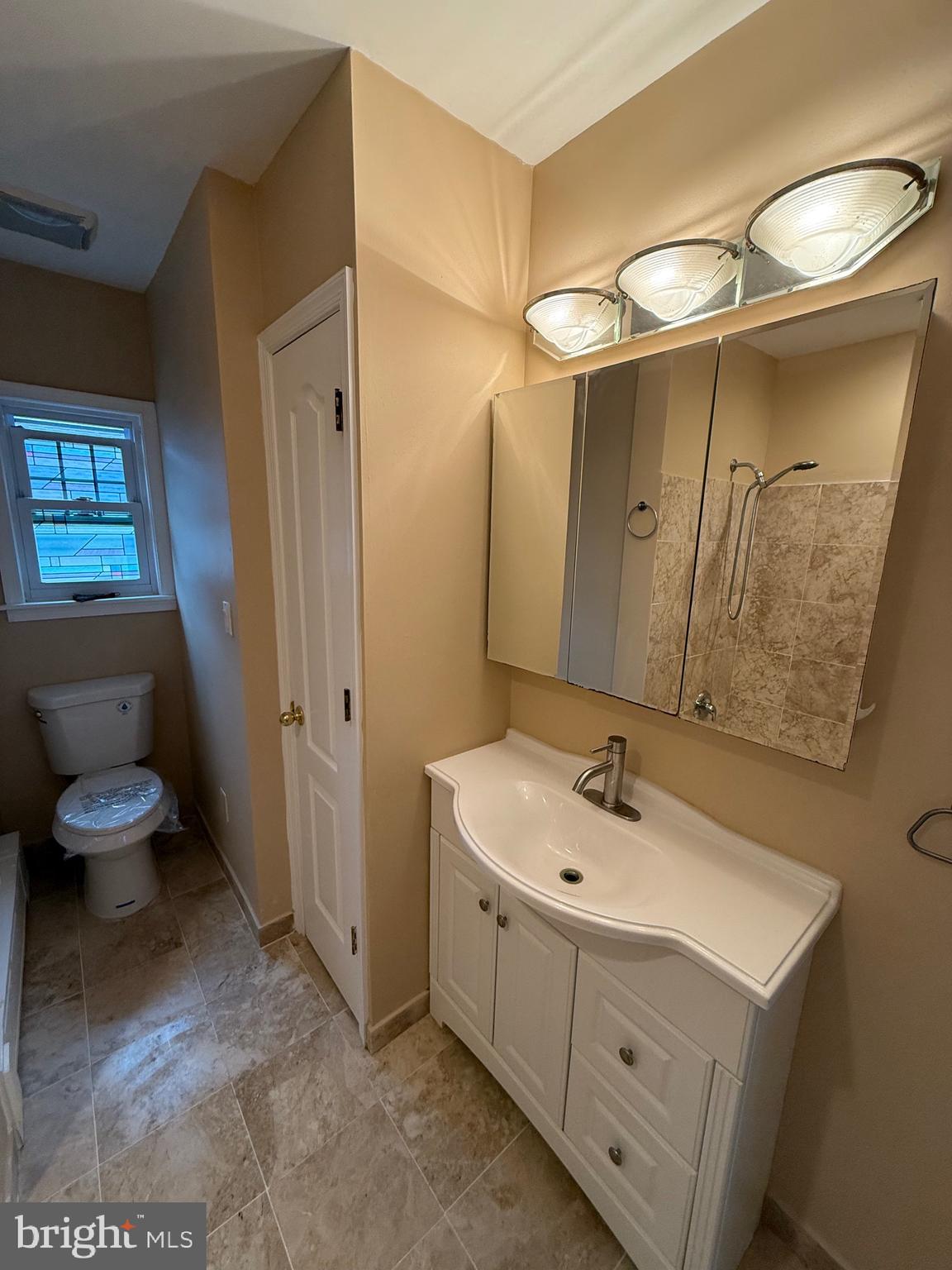 232 South Highland Road Springfield, PA 19064 - Photo 23 of 58 a bathroom with a sink mirror and toilet