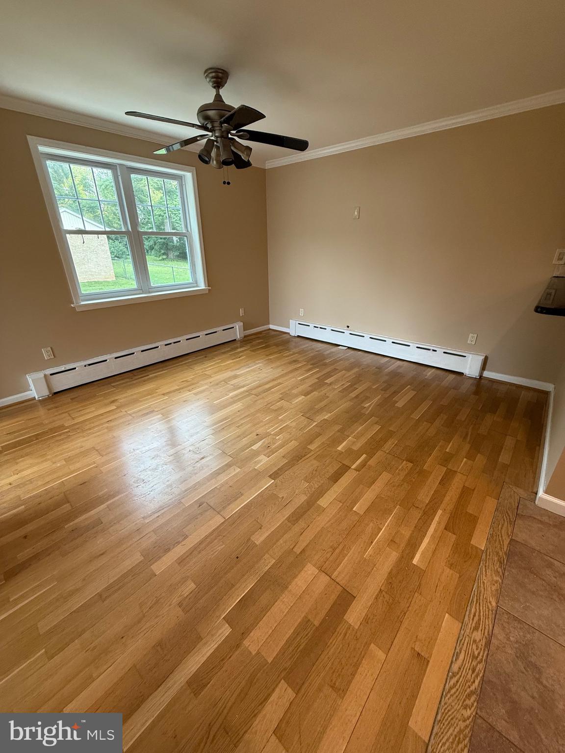 232 South Highland Road Springfield, PA 19064 - Photo 28 of 58 an empty room with wooden floor fan and windows