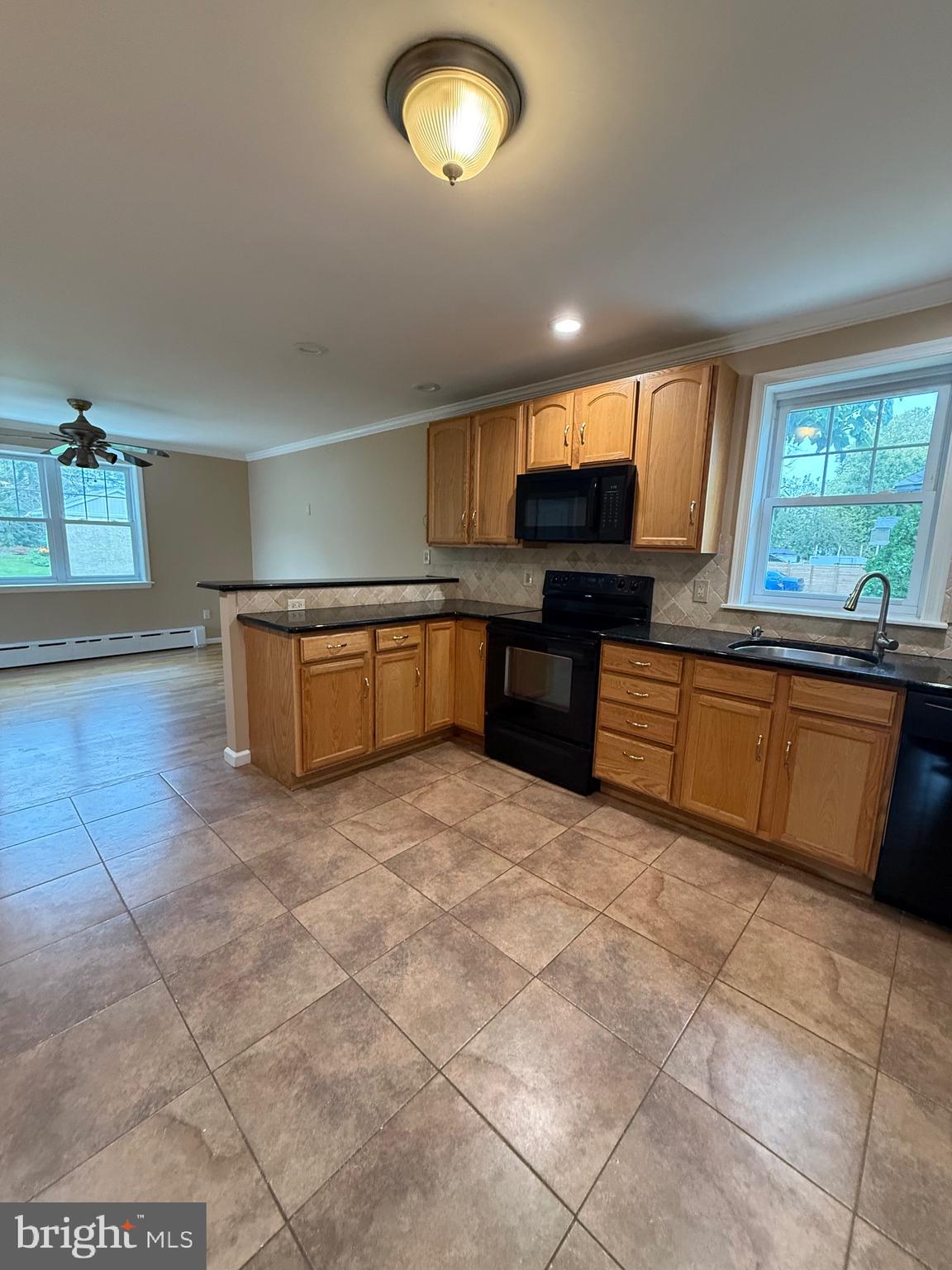 232 South Highland Road Springfield, PA 19064 - Photo 31 of 58 a large kitchen with stainless steel appliances granite countertop a sink and cabinets