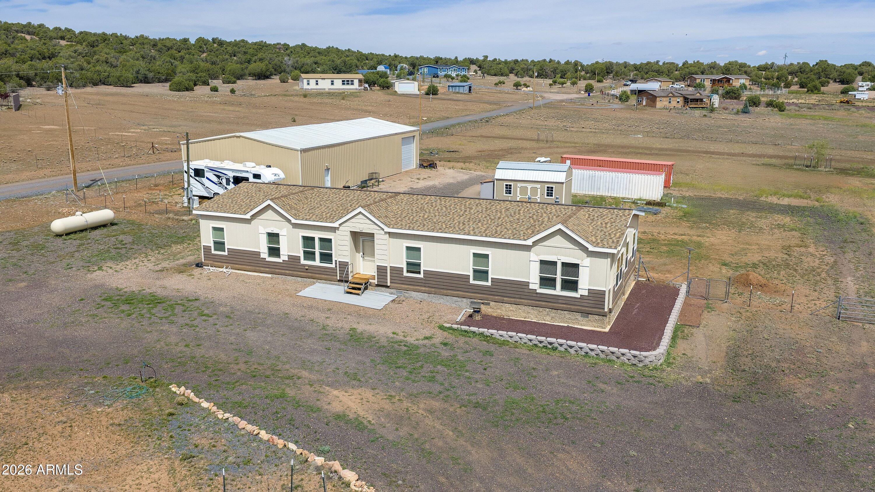 an aerial view of a house with a big yard
