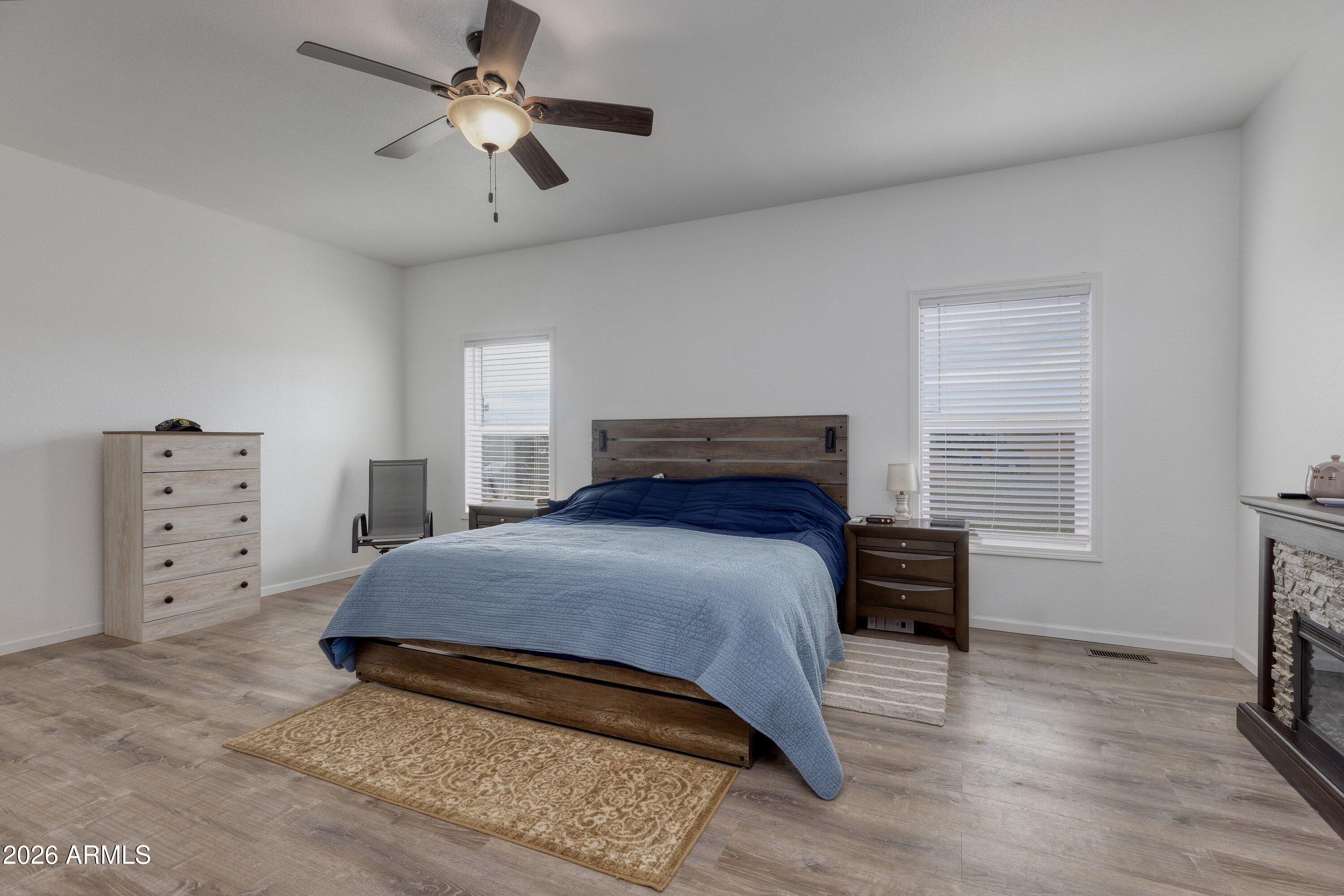 6644 Avanti Way Show Low, AZ 85901 - Photo 12 of 29 a bedroom with a bed and a chandelier