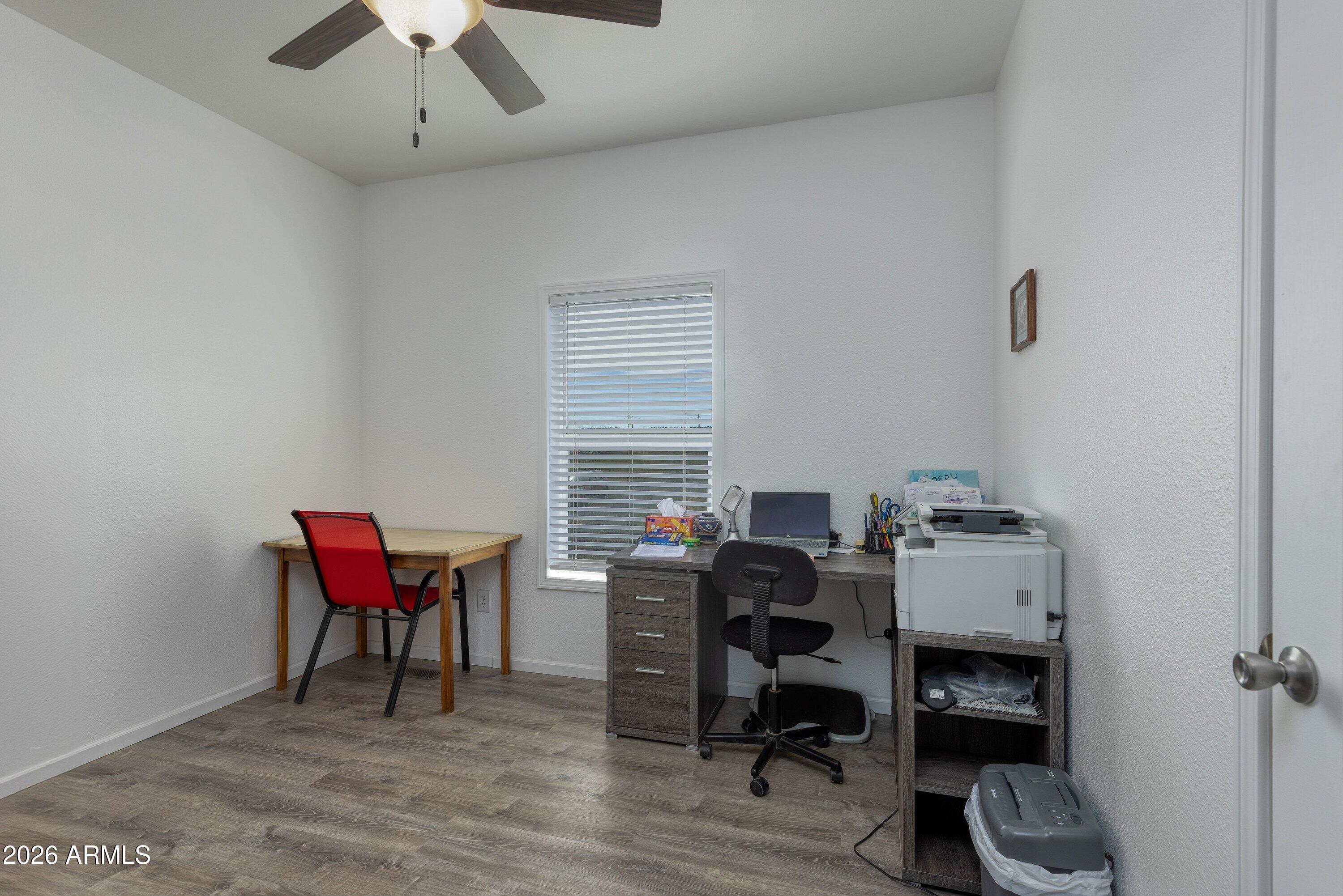 6644 Avanti Way Show Low, AZ 85901 - Photo 18 of 29 a view of a workspace with furniture and a window