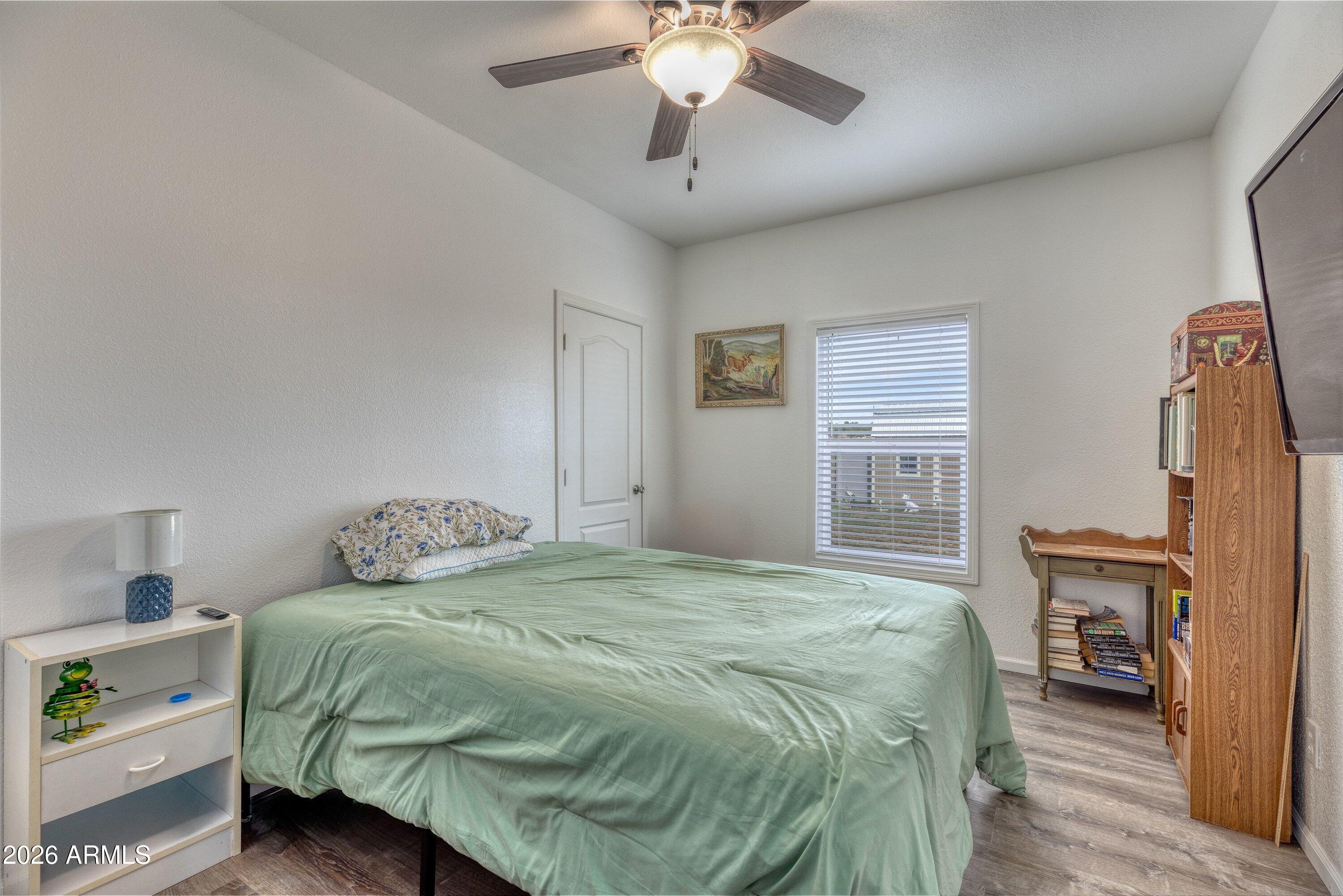6644 Avanti Way Show Low, AZ 85901 - Photo 20 of 29 a bedroom with a bed and a chandelier