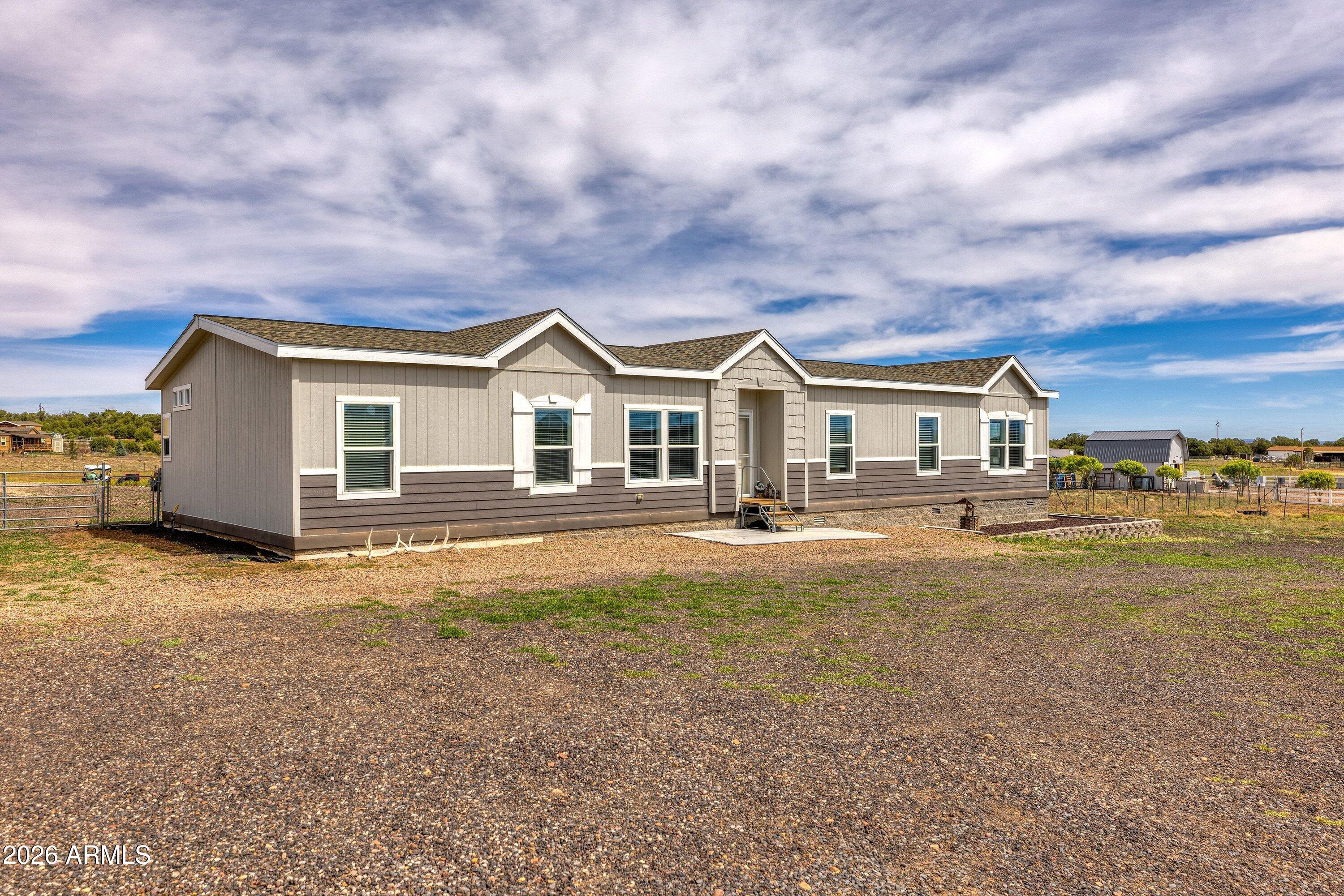 6644 Avanti Way Show Low, AZ 85901 - Photo 2 of 29 a front view of a house with a yard and garage