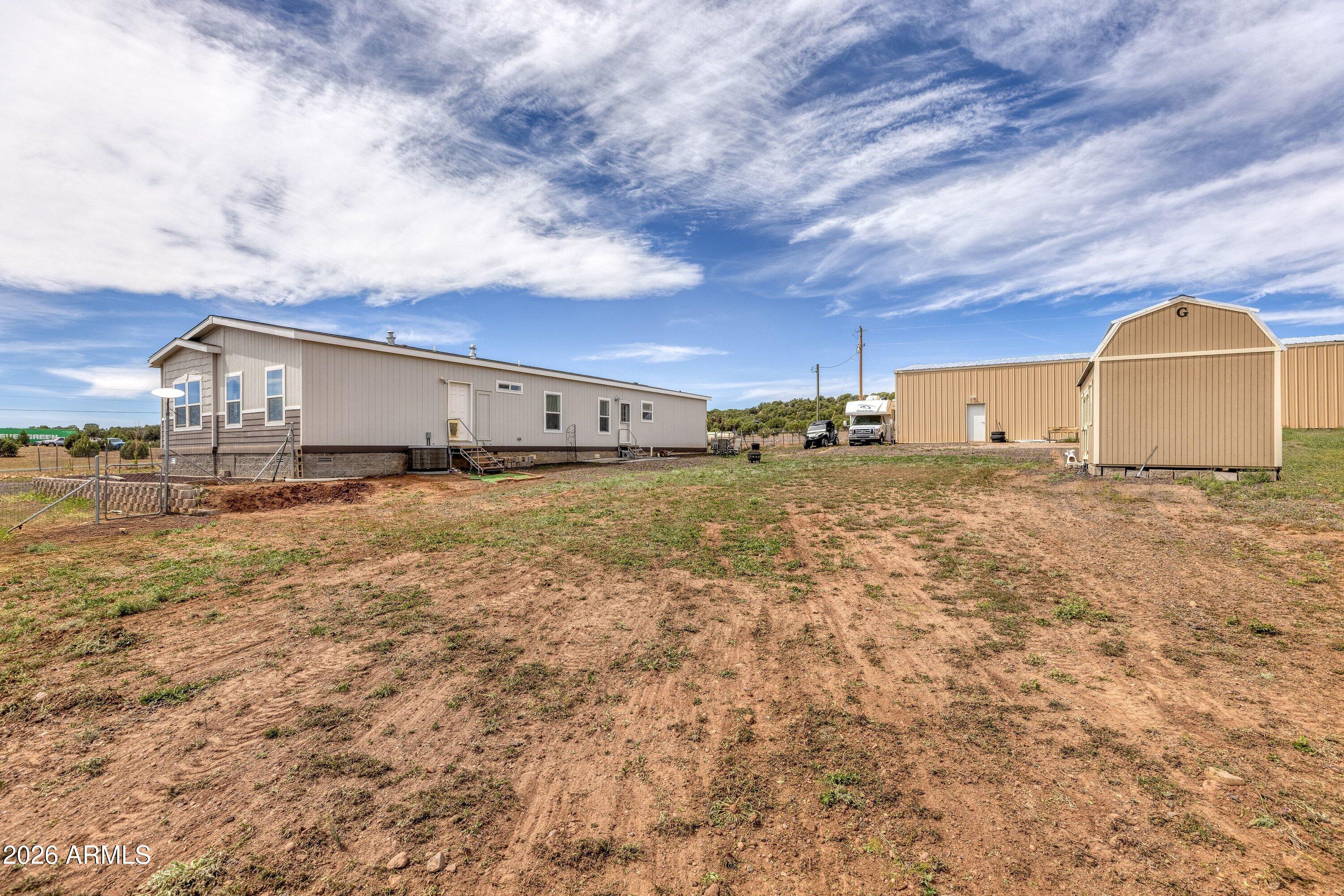 6644 Avanti Way Show Low, AZ 85901 - Photo 24 of 29 a view of a yard with an house and wooden fence