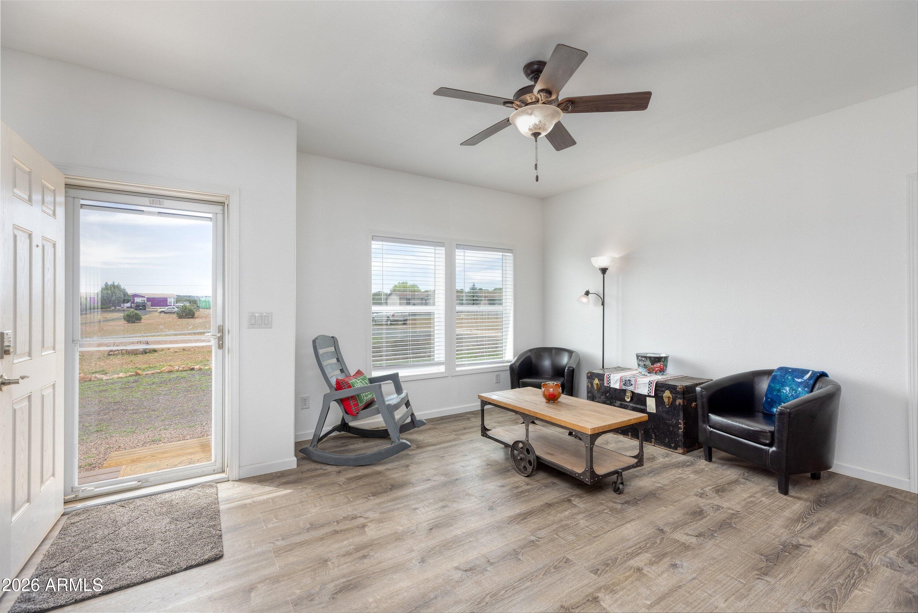 6644 Avanti Way Show Low, AZ 85901 - Photo 6 of 29 a living room with furniture and a flat screen tv
