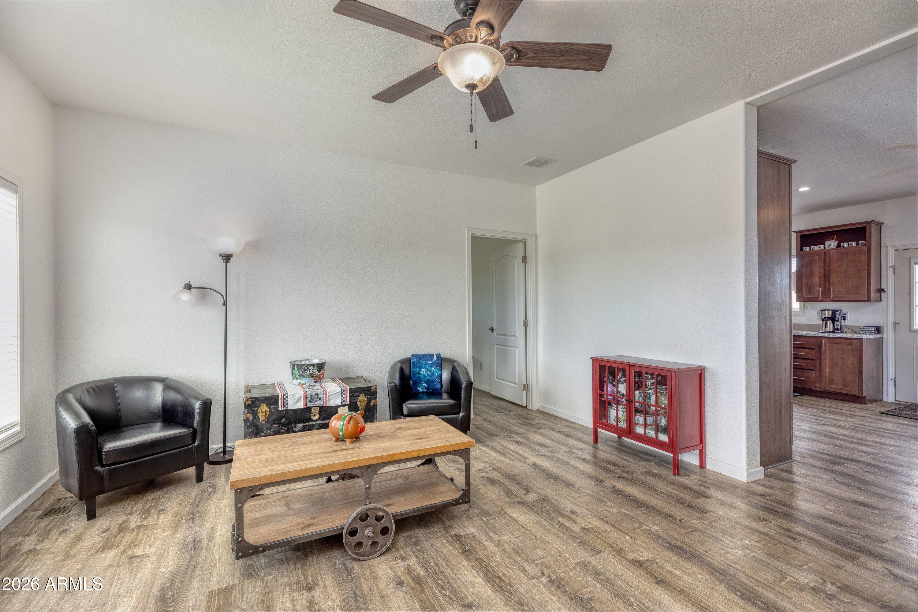 6644 Avanti Way Show Low, AZ 85901 - Photo 7 of 29 a living room with furniture and a wooden floor