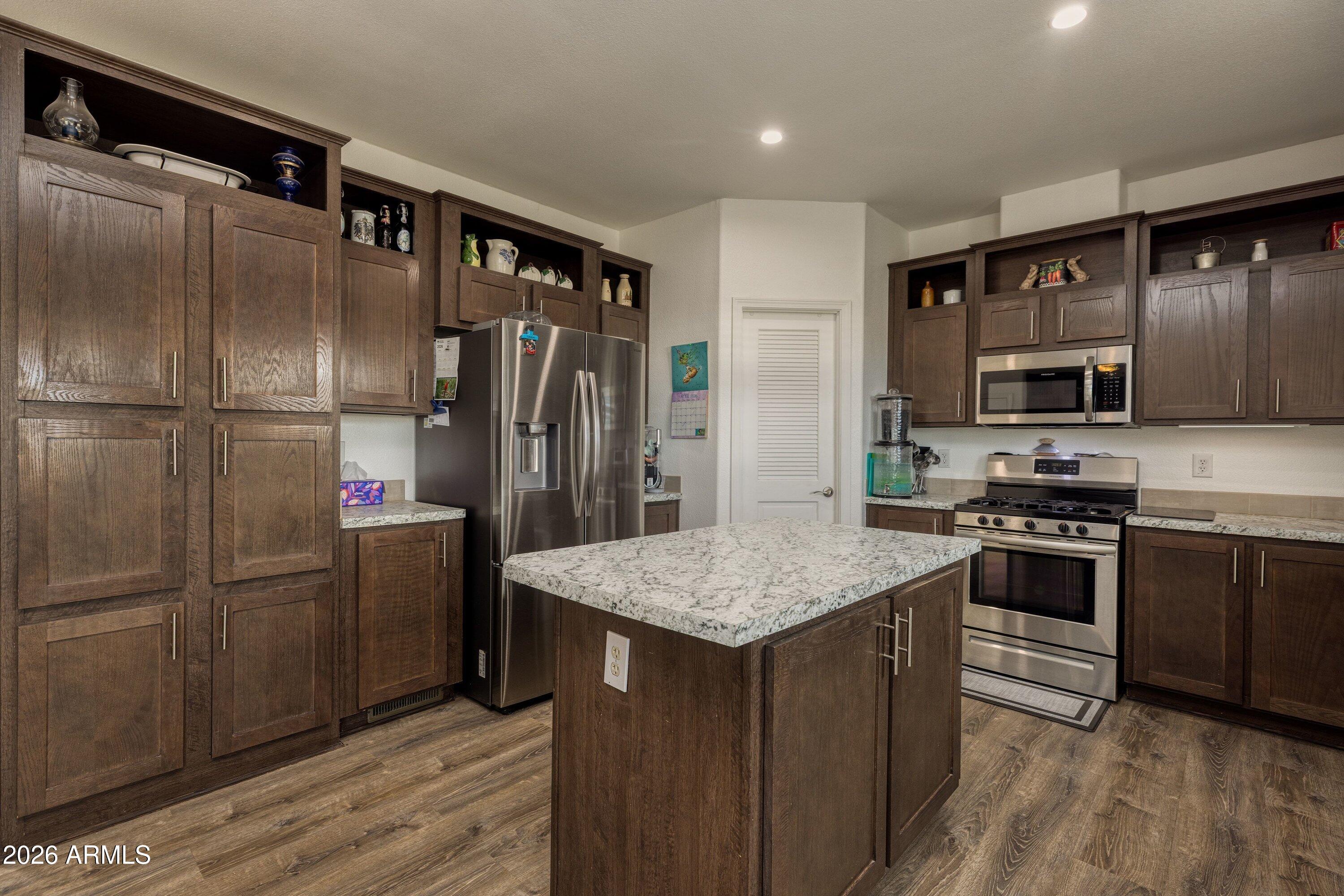 6644 Avanti Way Show Low, AZ 85901 - Photo 10 of 29 a kitchen with stainless steel appliances granite countertop a refrigerator and a stove top oven