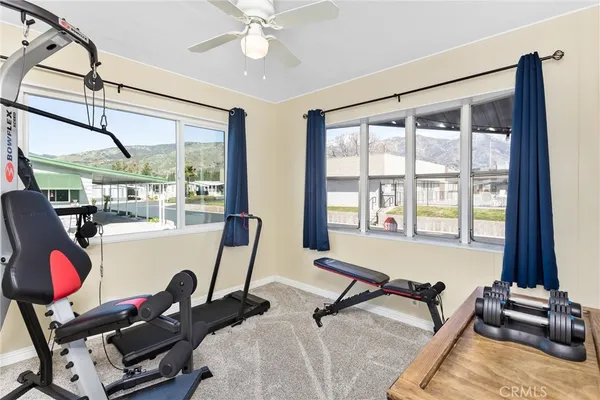 a room with gym equipment and a large window