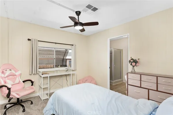 a bedroom with a bed and a desk