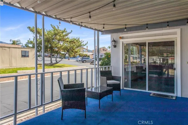 a view of a porch with furniture and wooden deck
