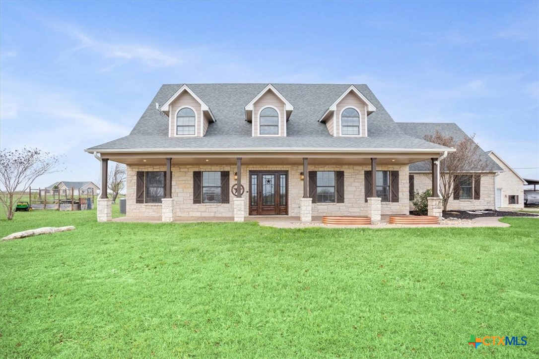 8600 Five Wells Road Rogers, TX 76569 - Photo 2 of 47 a front view of a residential houses with yard and green space