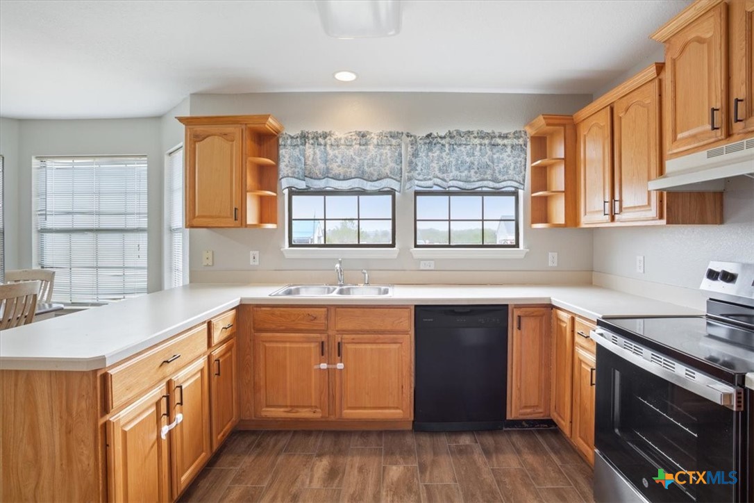 8600 Five Wells Road Rogers, TX 76569 - Photo 38 of 47 a kitchen with a sink stove and cabinets