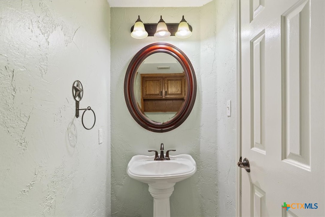 8600 Five Wells Road Rogers, TX 76569 - Photo 9 of 47 a bathroom with a sink and a mirror