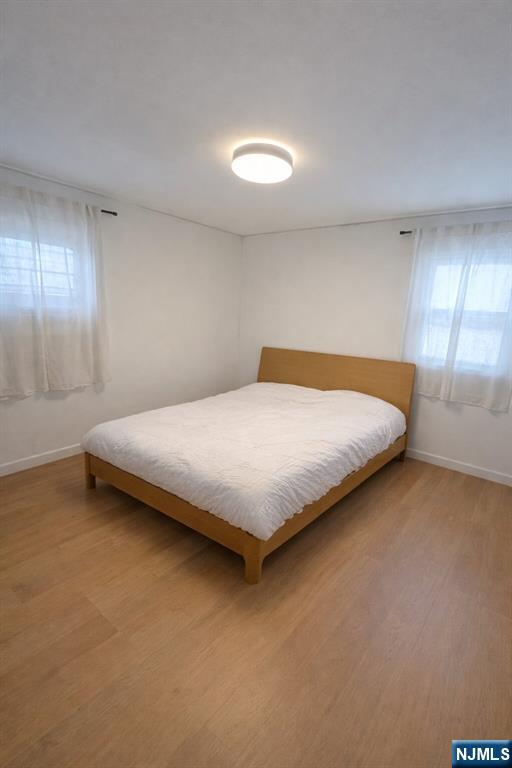 122 Dean Drive, Unit 1 Tenafly, NJ 07670 - Photo 11 of 15 a bedroom with a bed and window