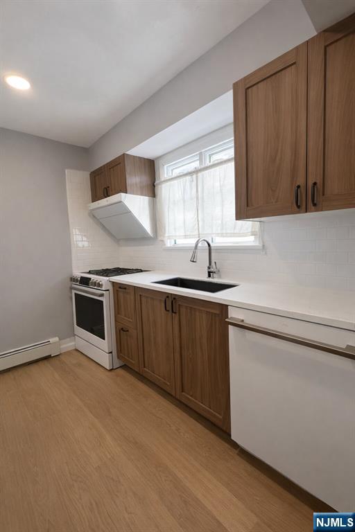 122 Dean Drive, Unit 1 Tenafly, NJ 07670 - Photo 3 of 15 a kitchen with a sink cabinets and stainless steel appliances