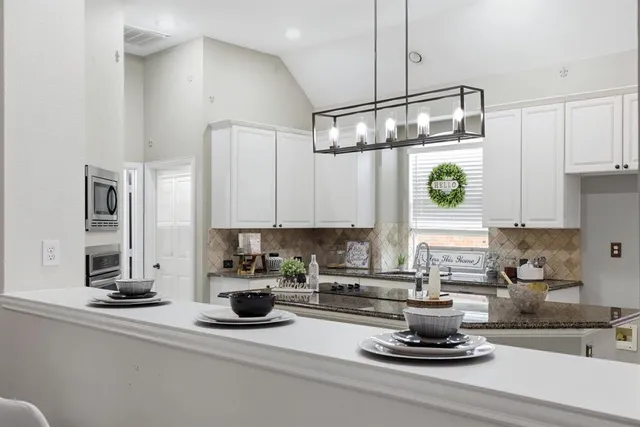 a kitchen with a sink and appliances