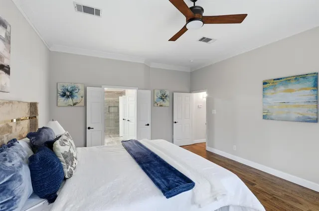 a bedroom with a bed and a painting on the wall