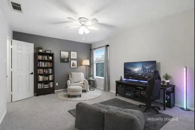 an empty room with fan and entrance