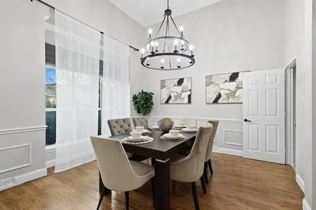 a view of a dining room with furniture wooden floor and chandelier