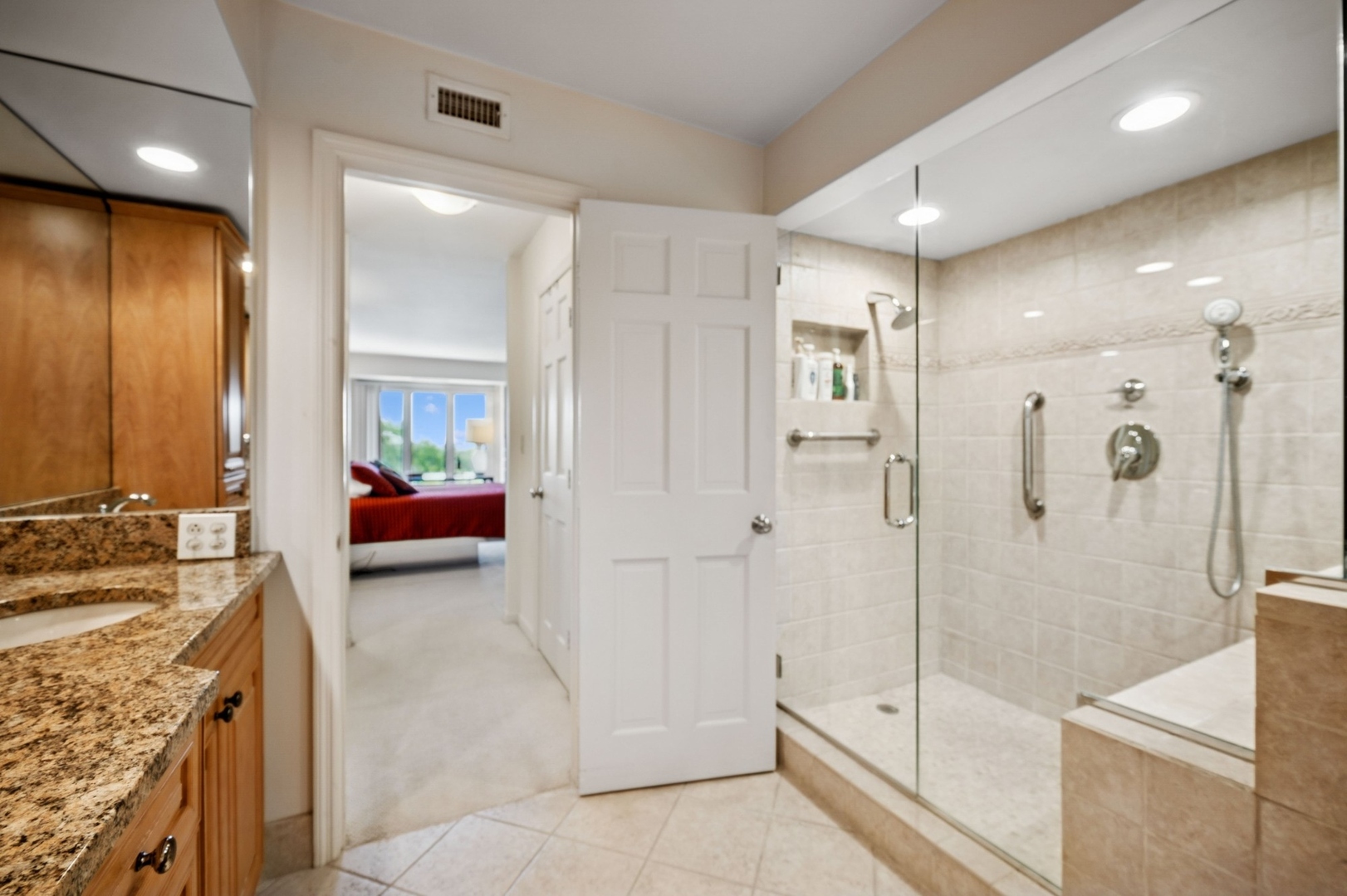 1671 Mission Hills Road, Unit 501 Northbrook, IL 60062 - Photo 21 of 27 a spacious bathroom with a granite countertop sink mirror and shower
