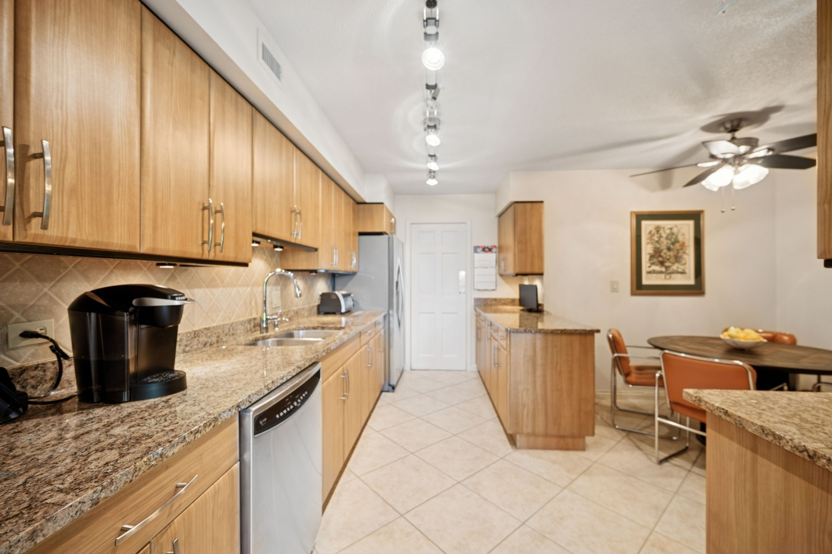 1671 Mission Hills Road, Unit 501 Northbrook, IL 60062 - Photo 10 of 27 a kitchen with granite countertop a sink a counter top space appliances and cabinets