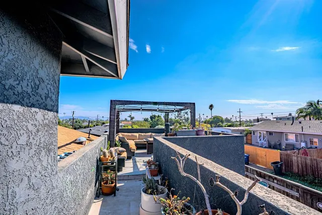 a bedroom with a bed a chandelier and a window