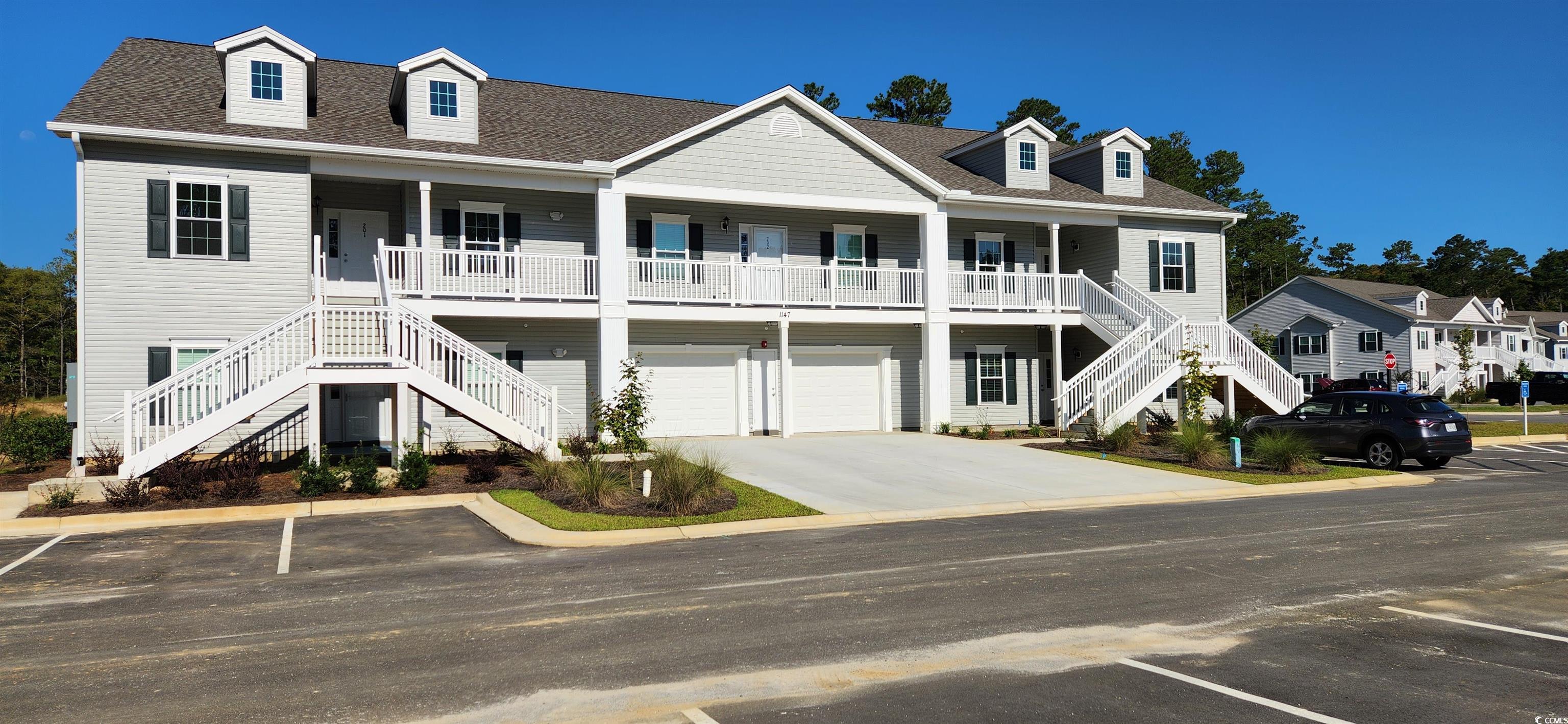 1147 Freeboard Street, Unit 201 Murrells Inlet, SC 29576 - Photo 1 of 38 Beach home with a garage and covered porch