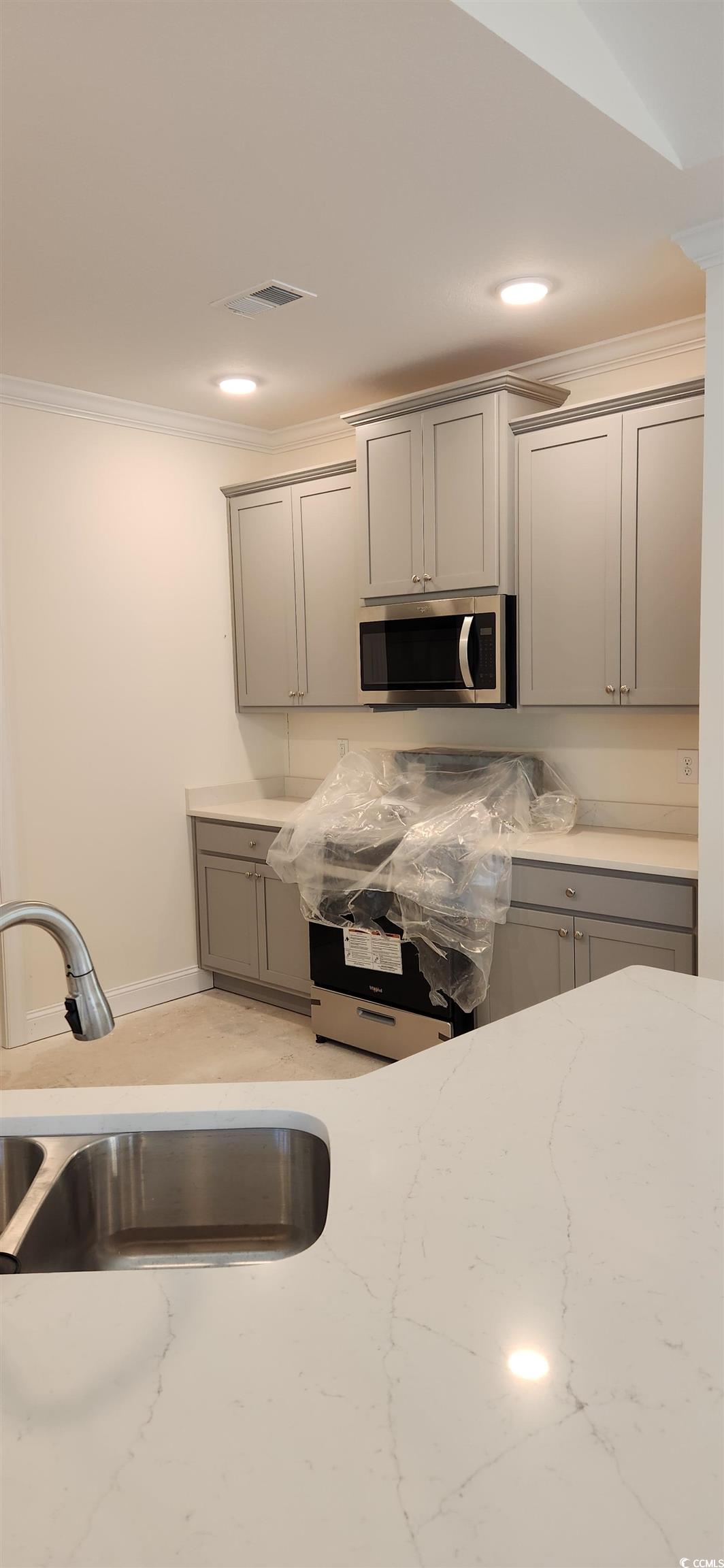 1147 Freeboard Street, Unit 201 Murrells Inlet, SC 29576 - Photo 29 of 38 Kitchen with ornamental molding, gray cabinets, and sink