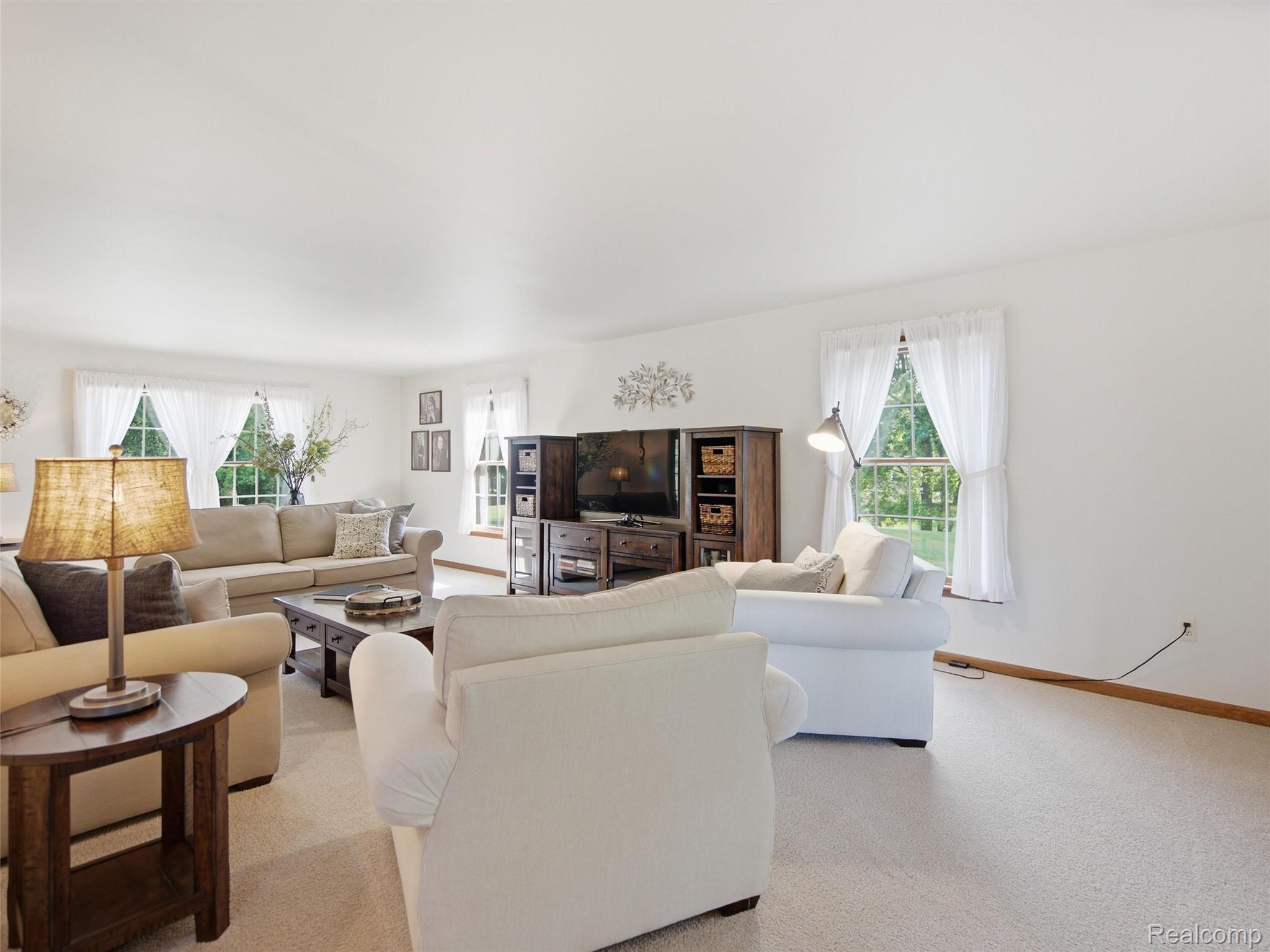 5449 Lum Road Attica, MI 48412 - Photo 27 of 82 Spacious living area featuring light-toned carpeting and multiple windows offering exterior views