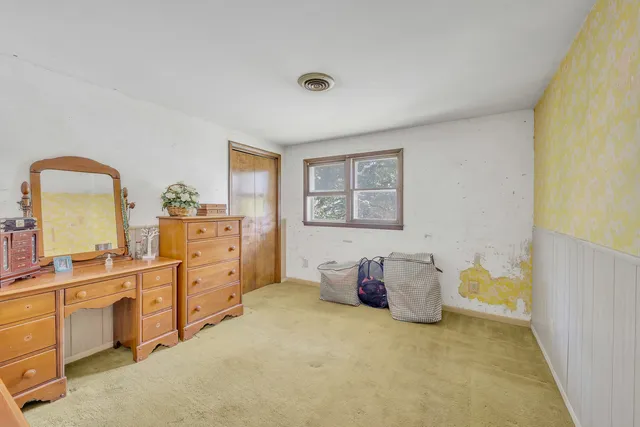 a bedroom with a bed and cabinets
