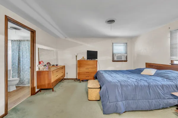 a bedroom with a bed and window