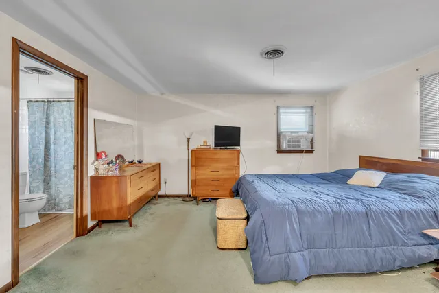 a bedroom with a bed and window