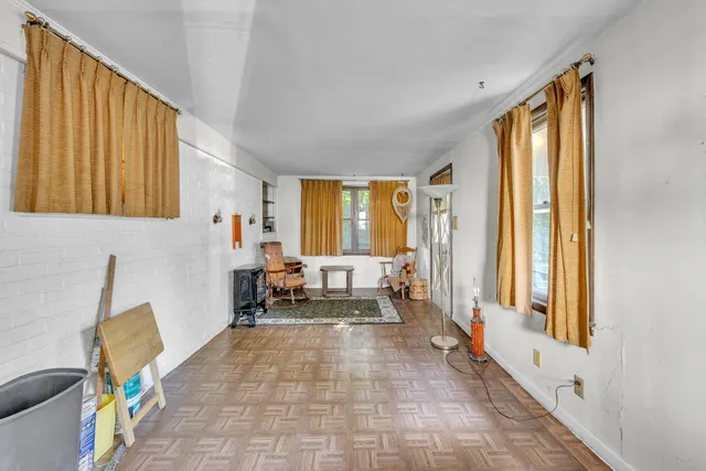 a living room with furniture and large windows