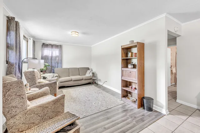 a living room with furniture and a book shelf