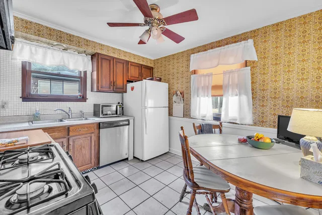 a kitchen with refrigerator cabinets and windows