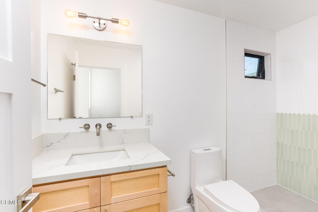 4947 Stratford Road Los Angeles, CA 90042 - Photo 11 of 30 a bathroom with a sink toilet and mirror