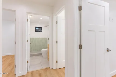 a view of hallway with wooden floor