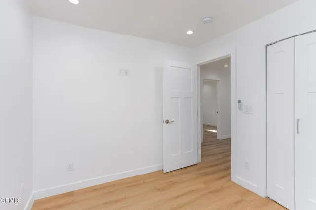 a view of hallway with wooden floor