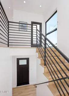 a kitchen with a sink a refrigerator and a stove top oven