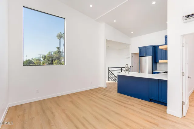 a kitchen with stainless steel appliances kitchen island granite countertop a refrigerator and a sink