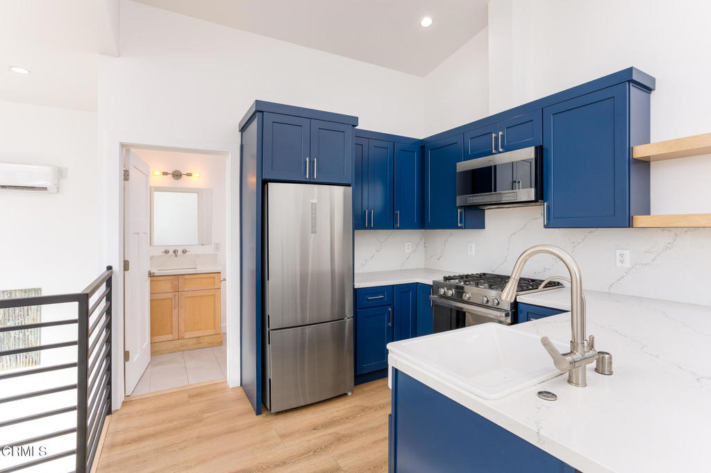 4947 Stratford Road Los Angeles, CA 90042 - Photo 6 of 30 a kitchen with a sink a refrigerator and a stove top oven