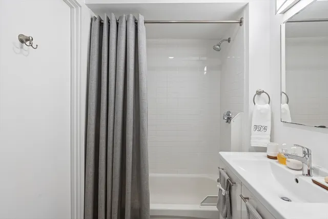 a hallway with table and flowerpot
