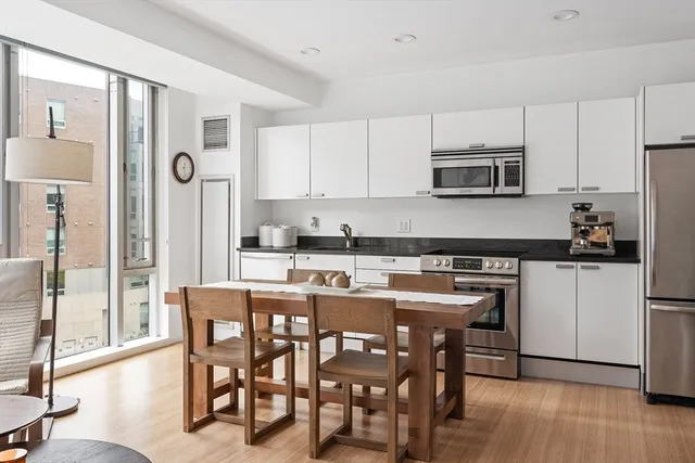 a kitchen with stainless steel appliances granite countertop a stove a sink and a refrigerator