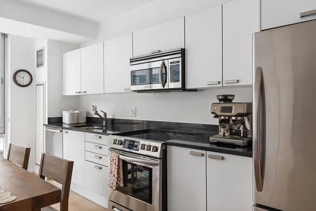 a living room with furniture and floor to ceiling windows