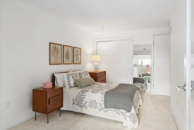 a bedroom with a bed and a mirror