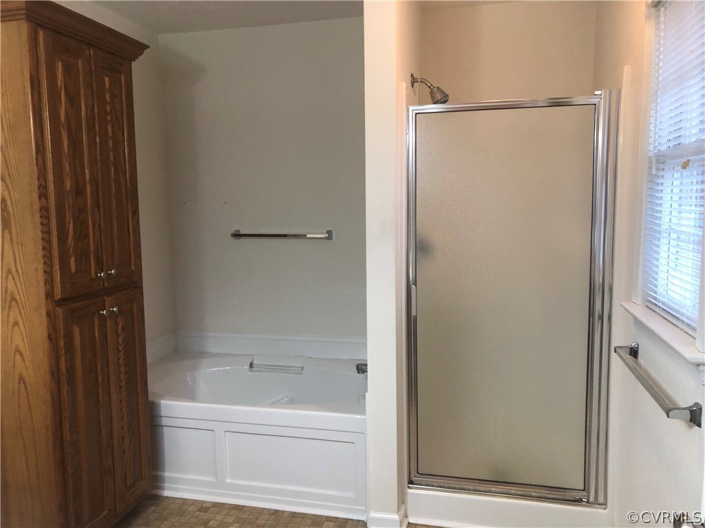 4797 Takach Road Prince George, VA 23875 - Photo 17 of 24 a bathroom with a bathtub and a shower