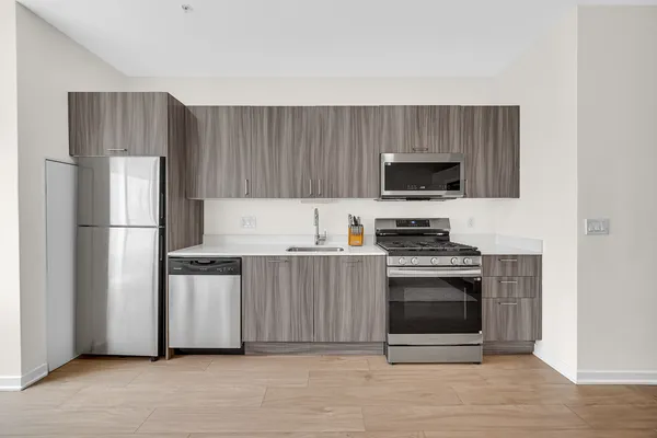 a living room with furniture a chandelier and a dining table