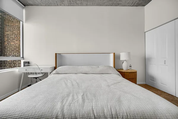 a bedroom with a bed and window